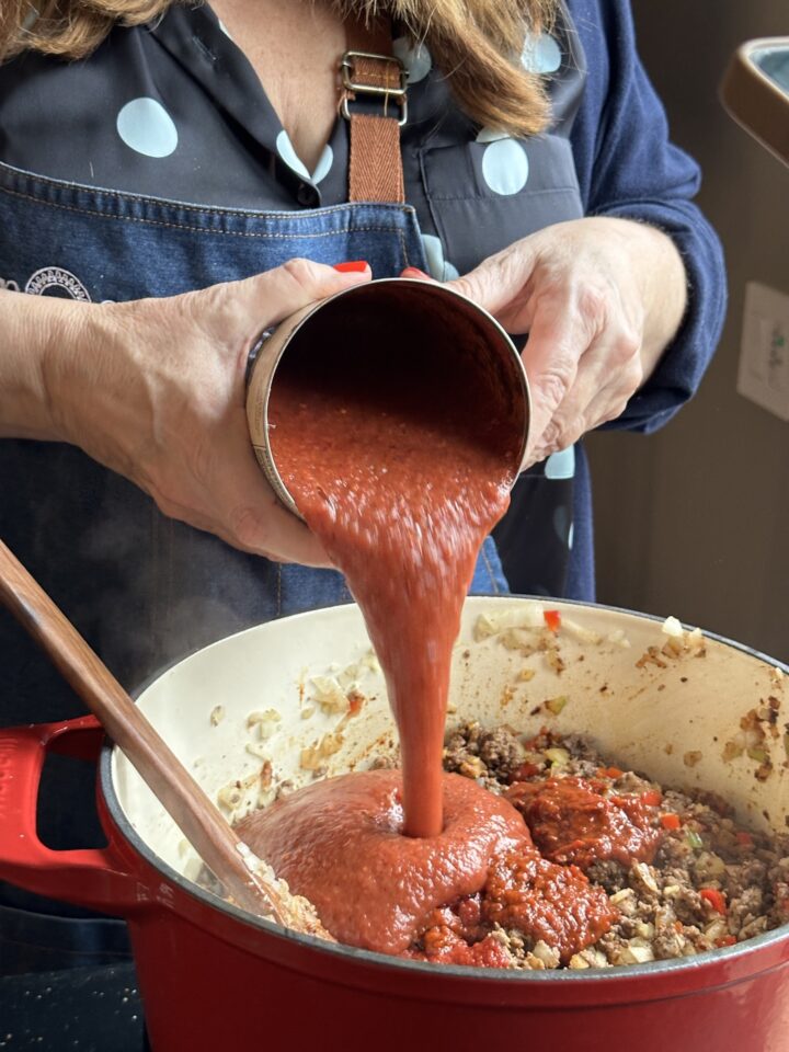 adding tomato sauce
