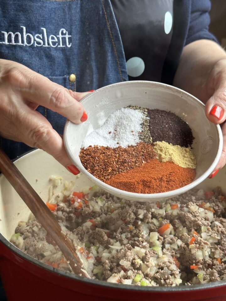 spices in a bowl over meat