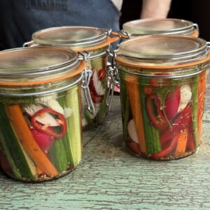 four jars of refrigerator pickles on a counter