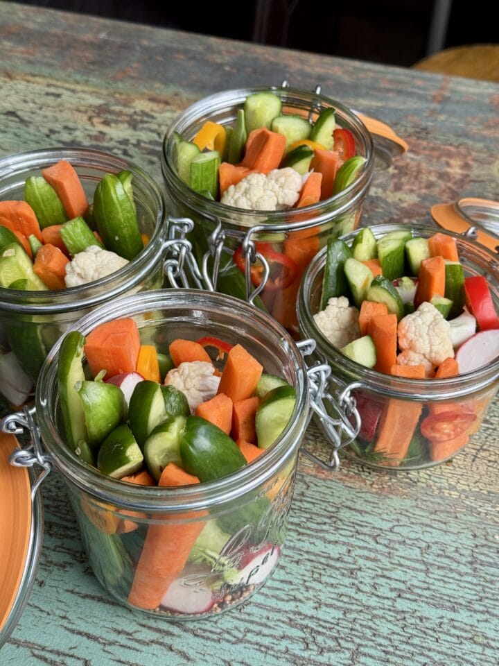 four open jars of refrigerator pickles