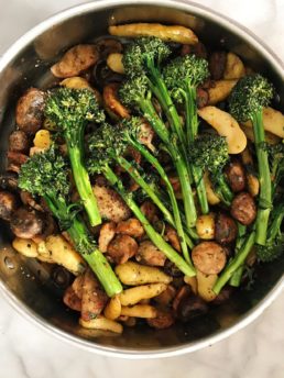 chicken, potatoes, and broccolini in a pan