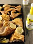 roasted chicken with lemons on a pan