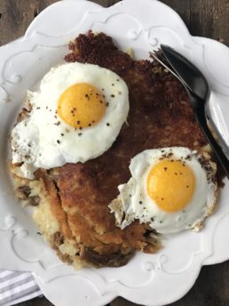 pork hash and eggs on a white plate