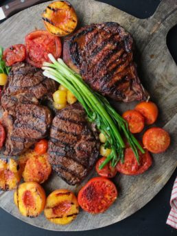 3 Ribeye Steaks with vegetables on a plattter