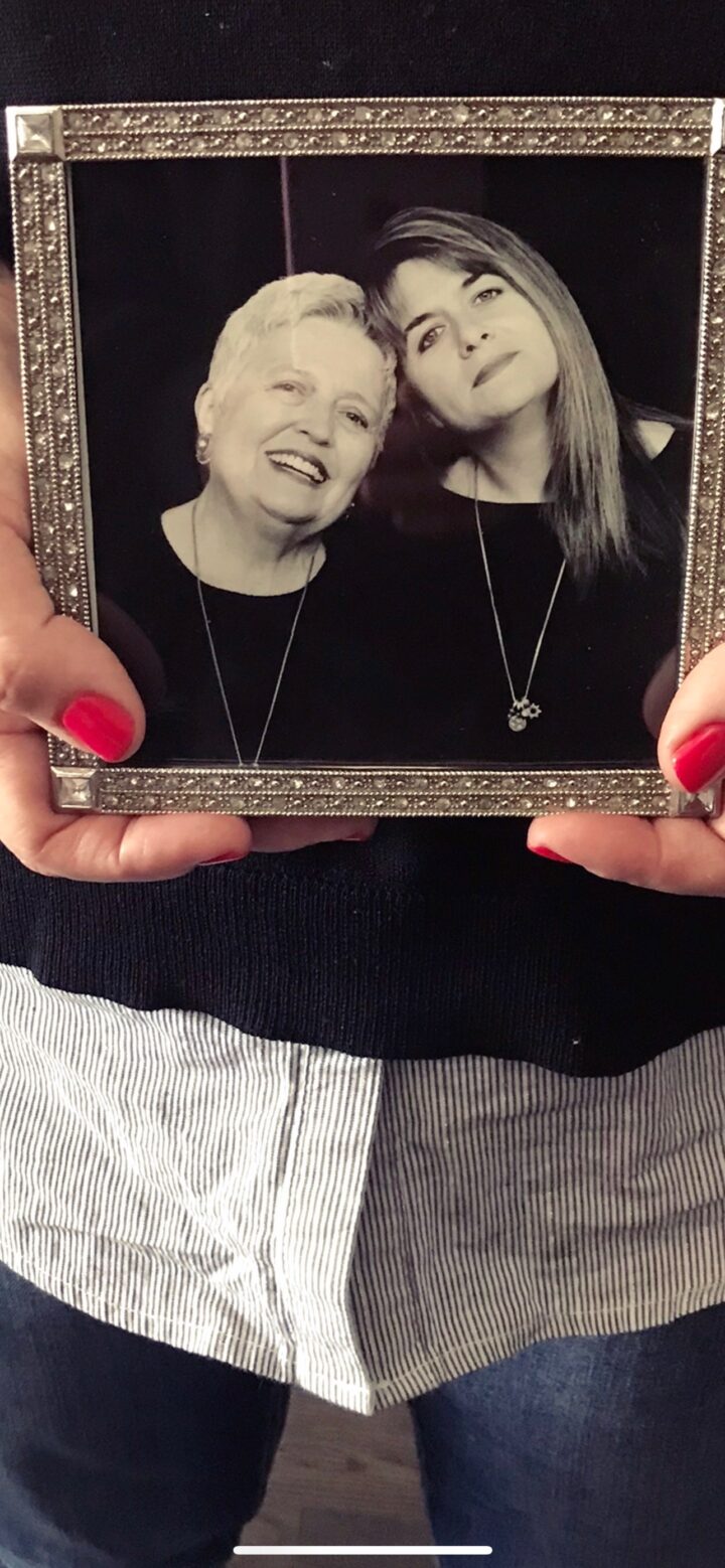 Teri holding a photo of her & her mom
