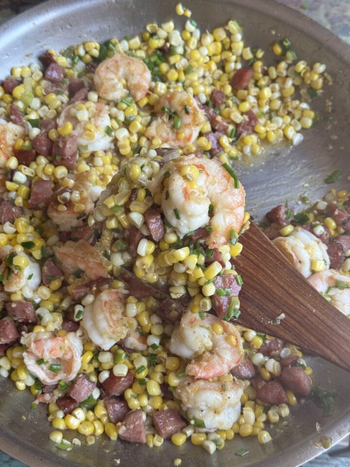 corn shrimp and chorizo saute in a pan
