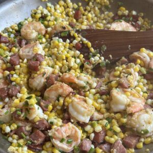 corn shrimp and chorizo saute in a pan