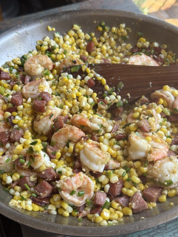 corn shrimp and chorizo saute in a pan