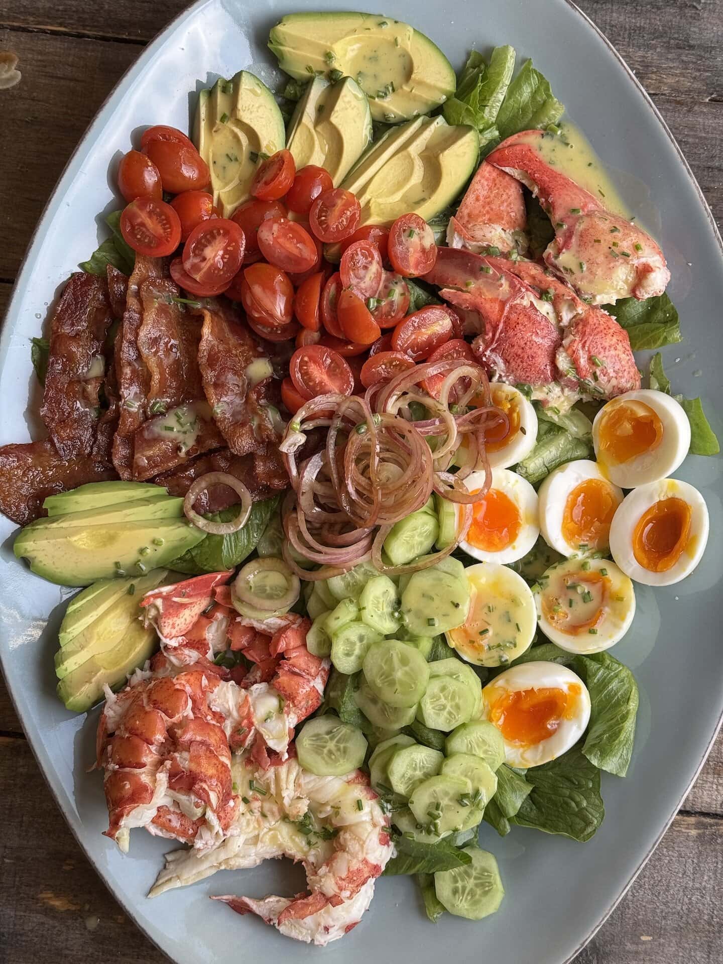 a photo of lobster cobb salad on a platter