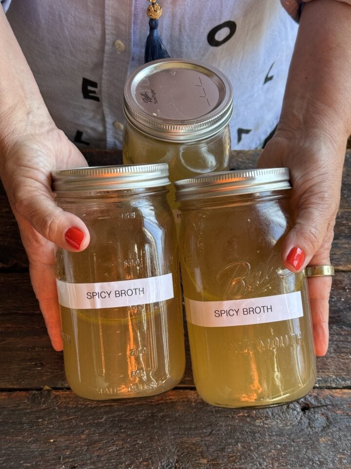 a photo of spicy chicken stock in two mason jars