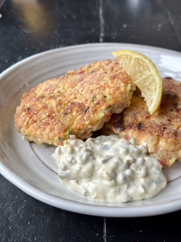 plated fish cakes with a slice of lemon & side of tartar sauce