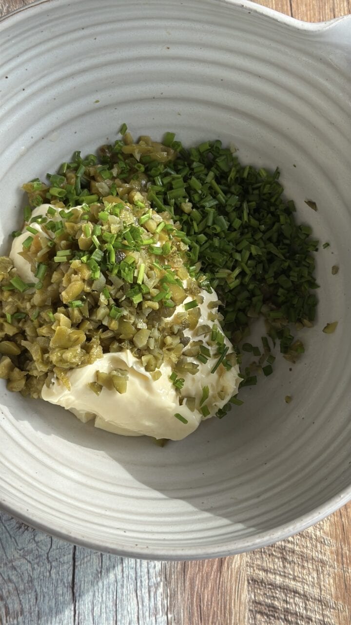 ingredients for tartar sauce in a white bowl