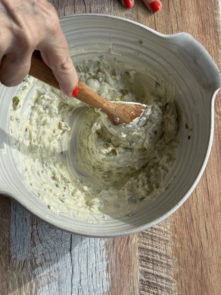 tartar sauce stirred together with a wooden spoon