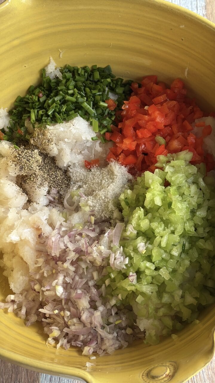 ingredients for white fish cakes in a yellow bowl