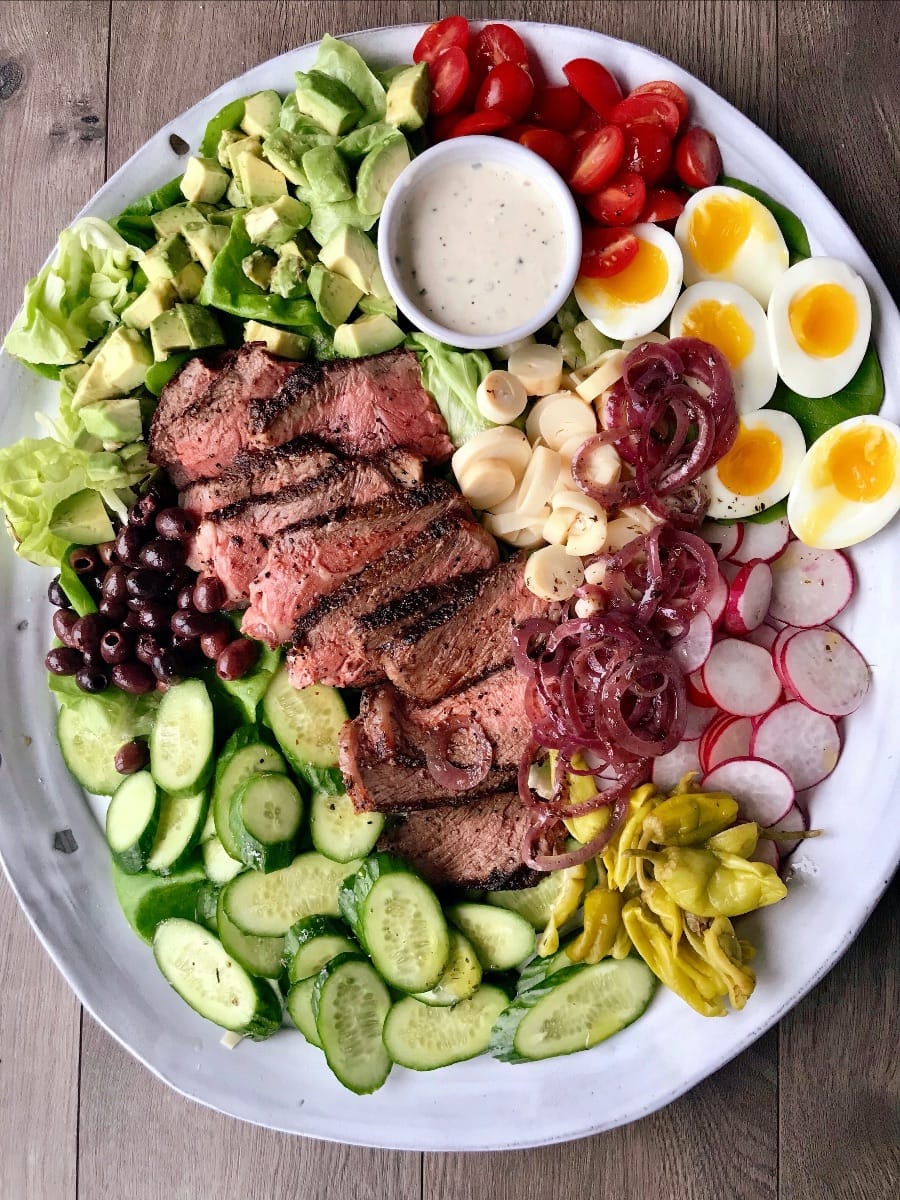 pepper steak salad on a white platter