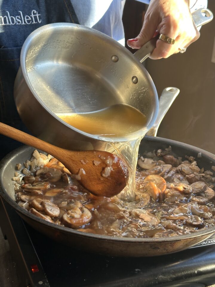 pouring broth into pan