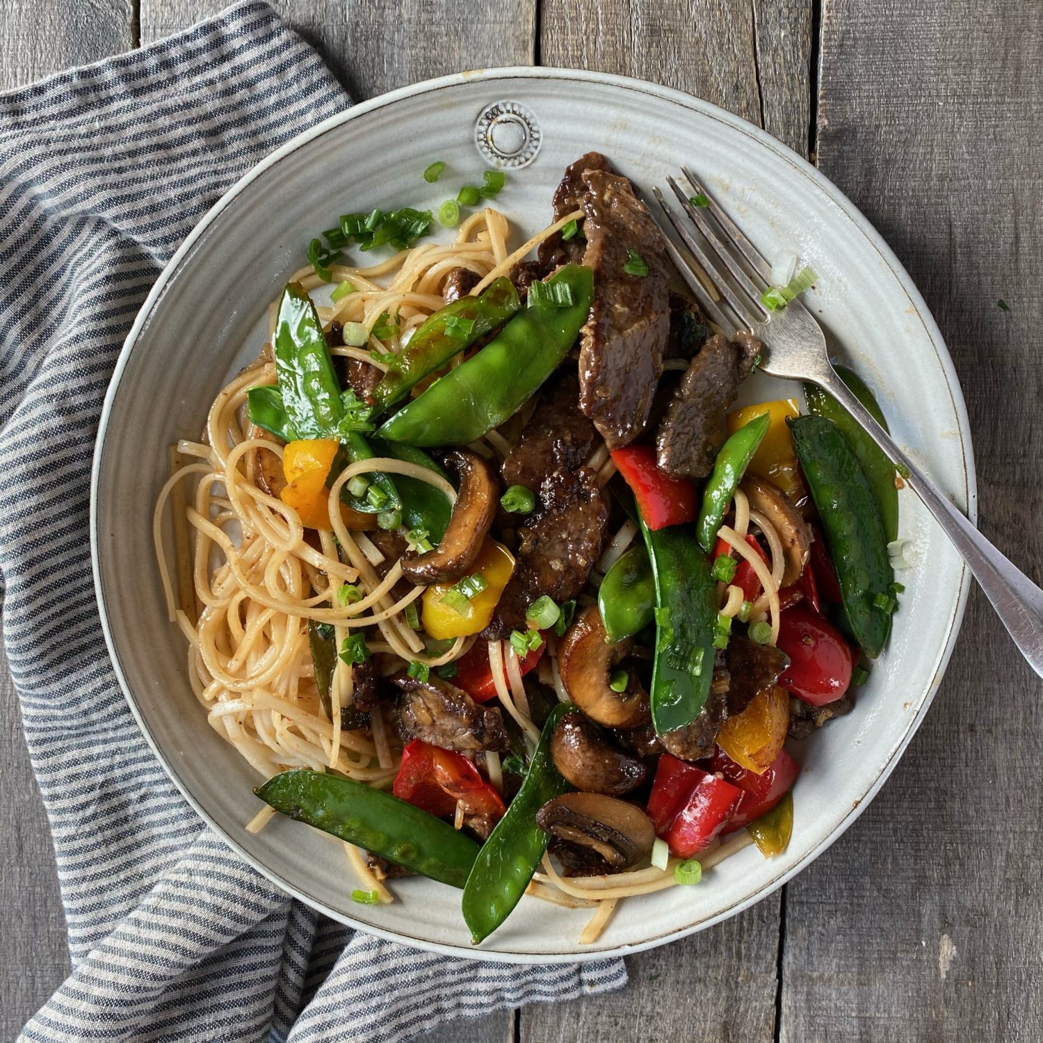 beef stir fry with rice noodles in an oatmeal hurley plate