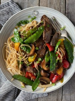beef stir fry with rice noodles in an oatmeal hurley plate