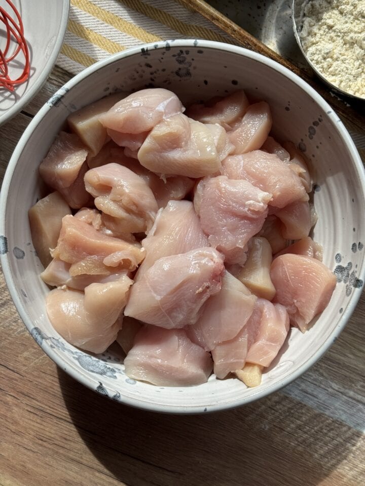 cubed chicken breast in a white bowl