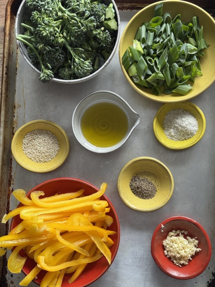 ingredients for stir fry with beef in small bowls on a sheet tray