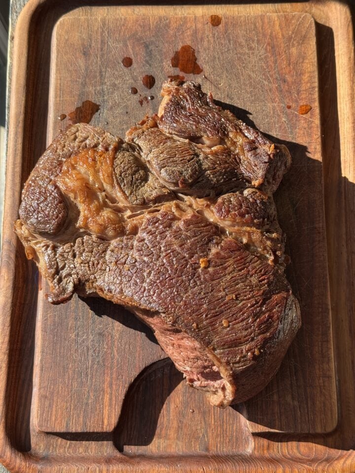 seared meat on a wooden cutting board