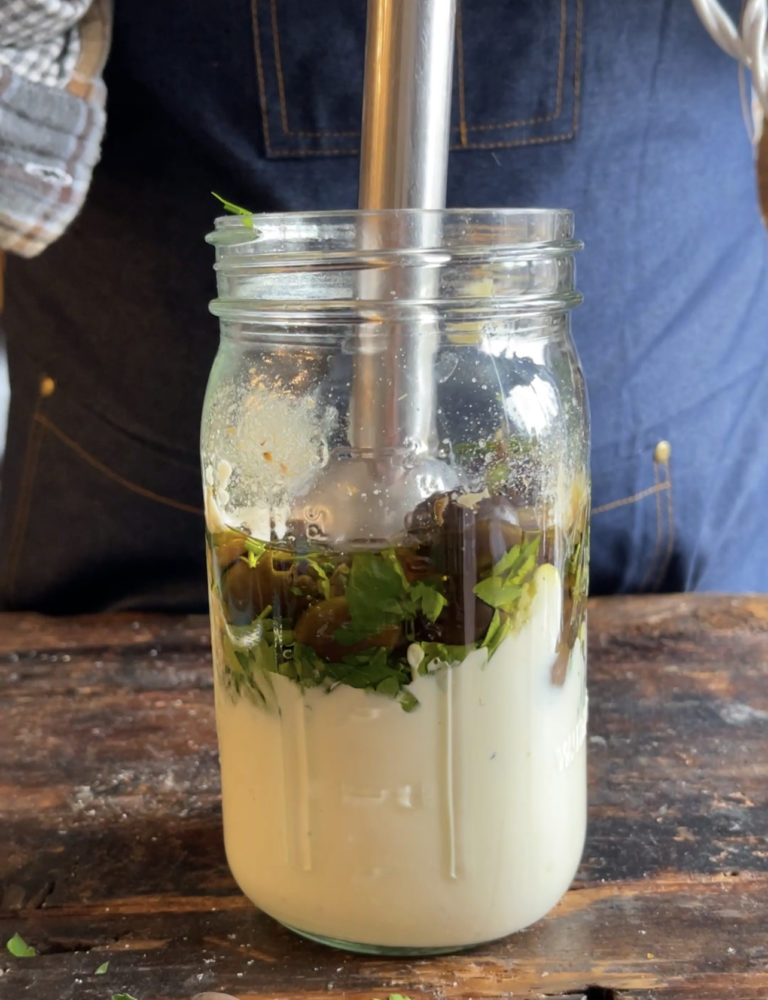 creamy olive dressing ingredients in a mason jar