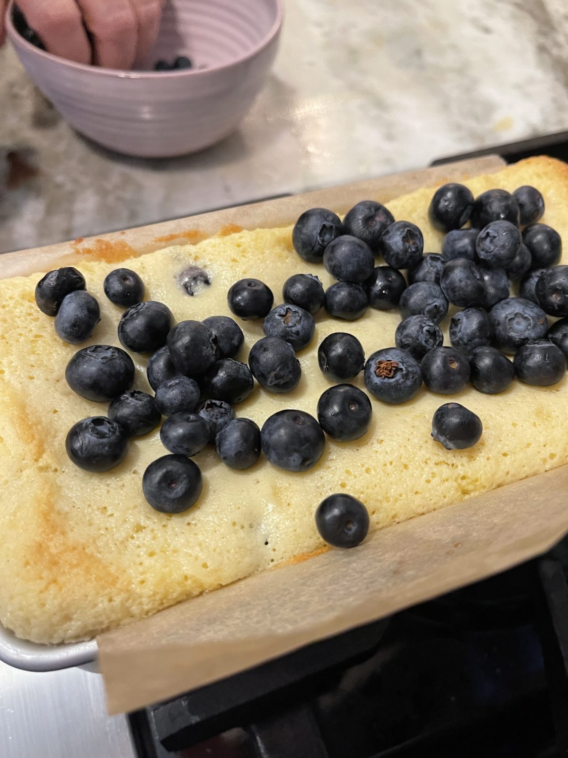 blueberries on top of partially cooked loaf