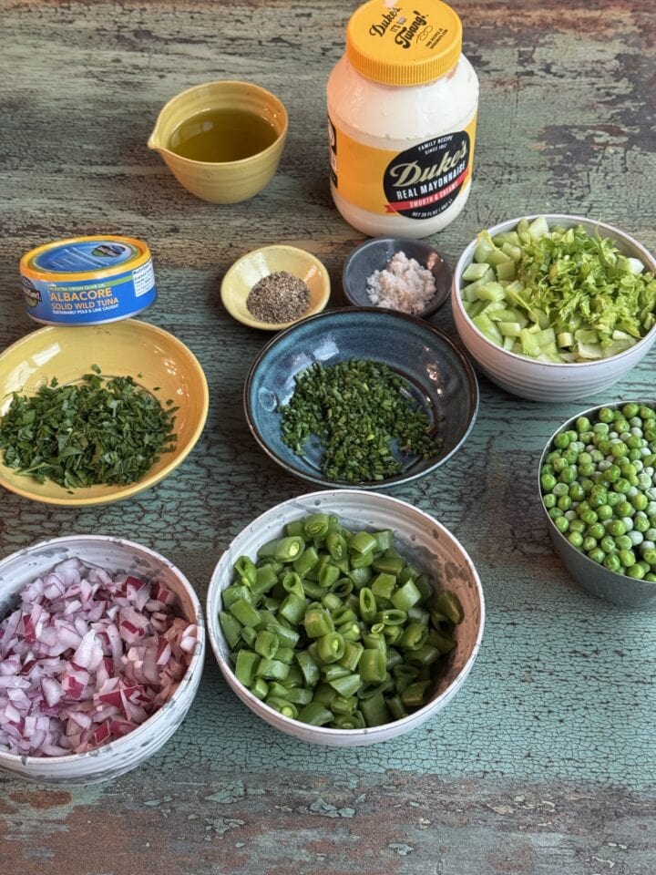 the ingredients for tuna pasta salad in small bowls