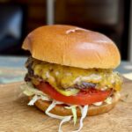 smashburger on a brioche bun on a cutting board
