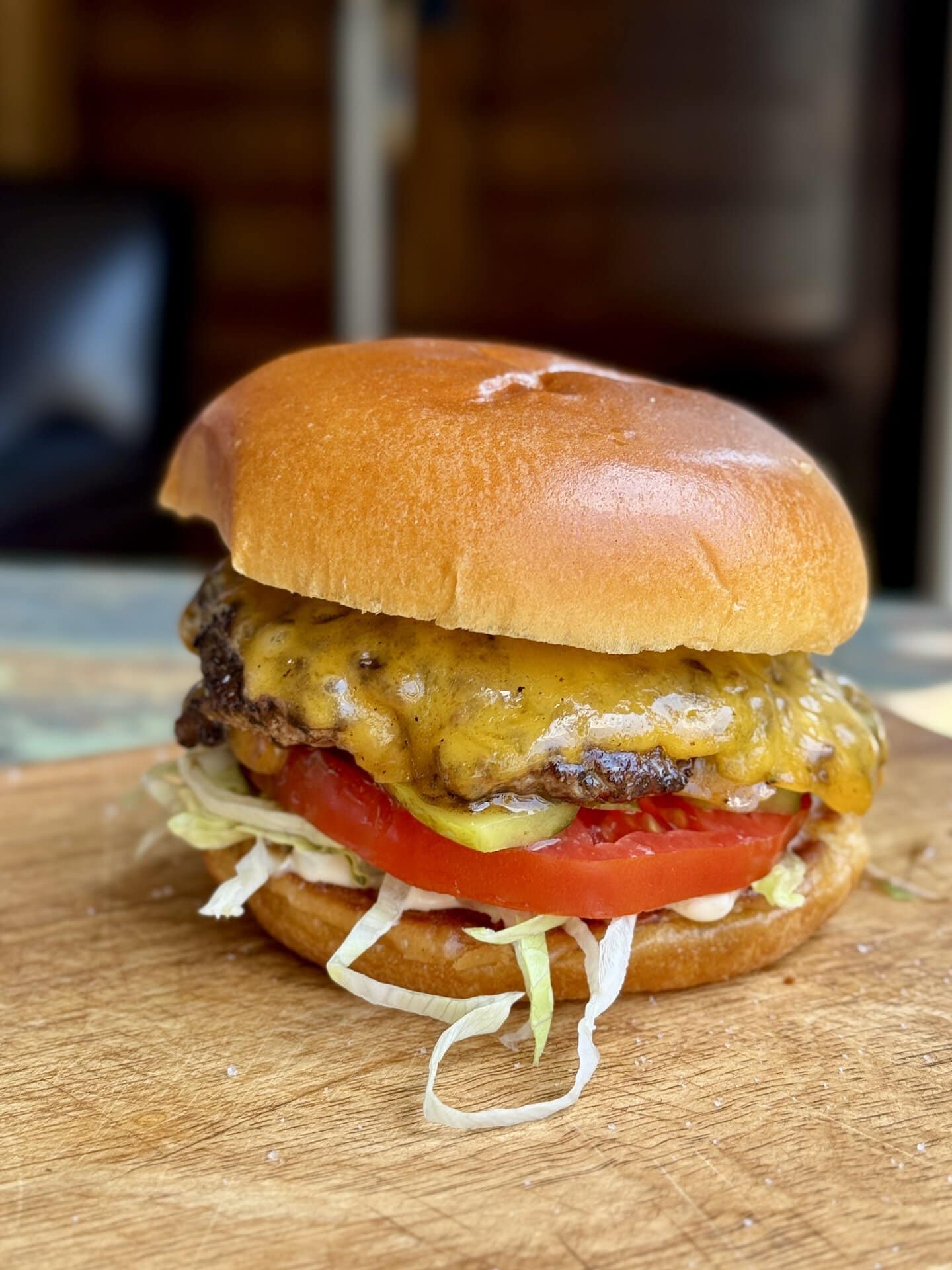 smashburger on a brioche bun on a cutting board