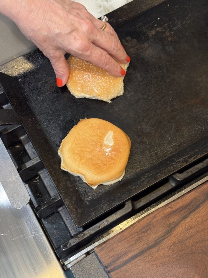 toasting burger buns on a griddle