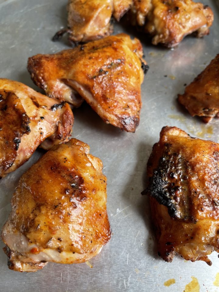 grilled chicken thighs on a sheet pan
