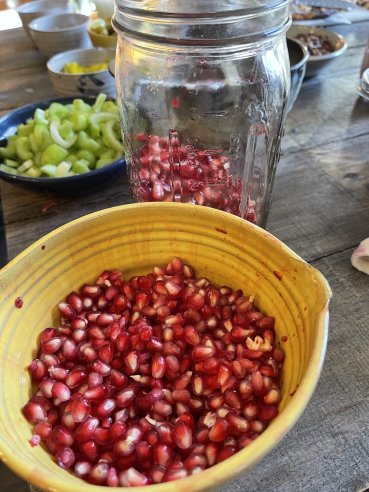 pomegranate arils in a yellow bowl