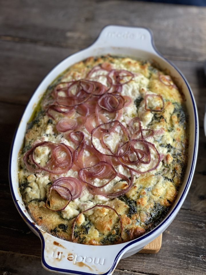 spinach and feta strata in a baking dish