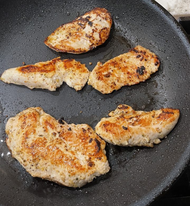 chicken cooking in a pan