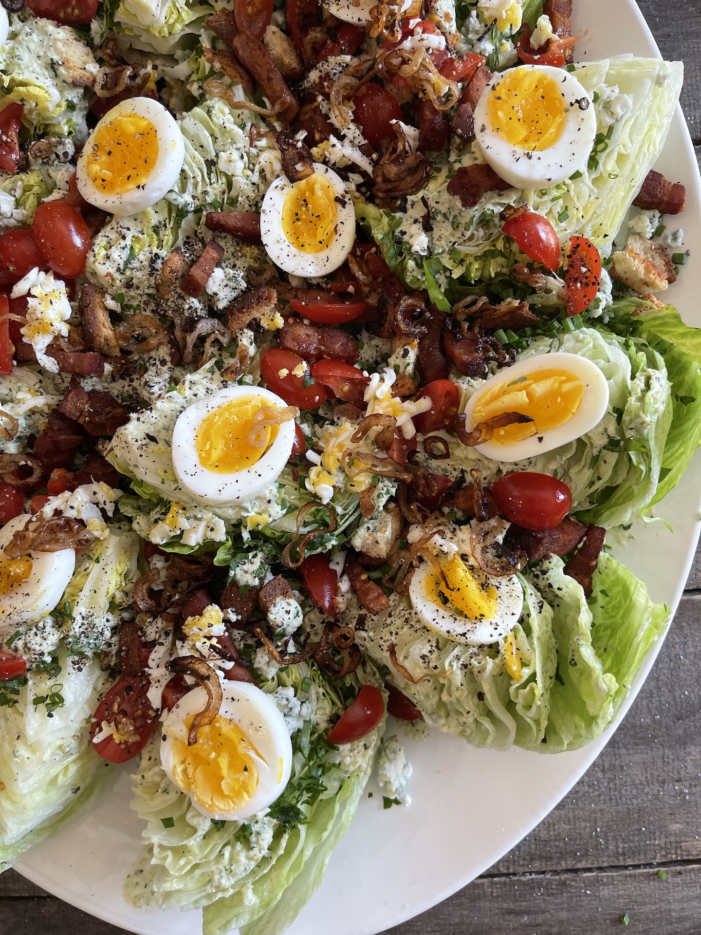 https://nocrumbsleft.net/wp-content/uploads/2023/02/close-up-on-winter-wedge-salad-on-a-white-platter.jpg