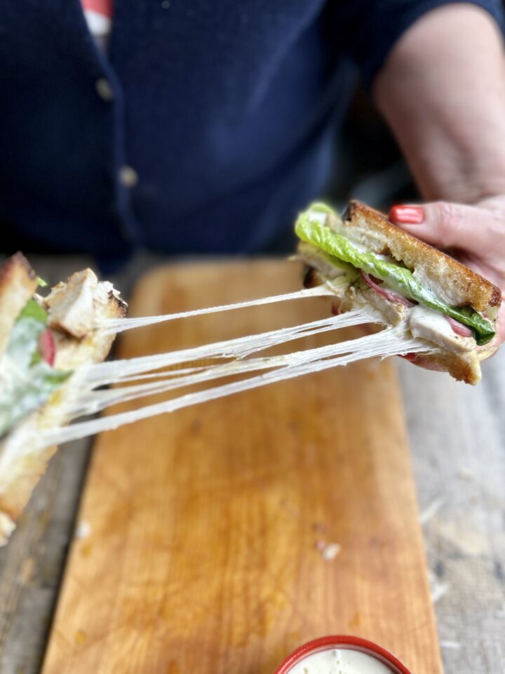 Cheese pull from sandwich.