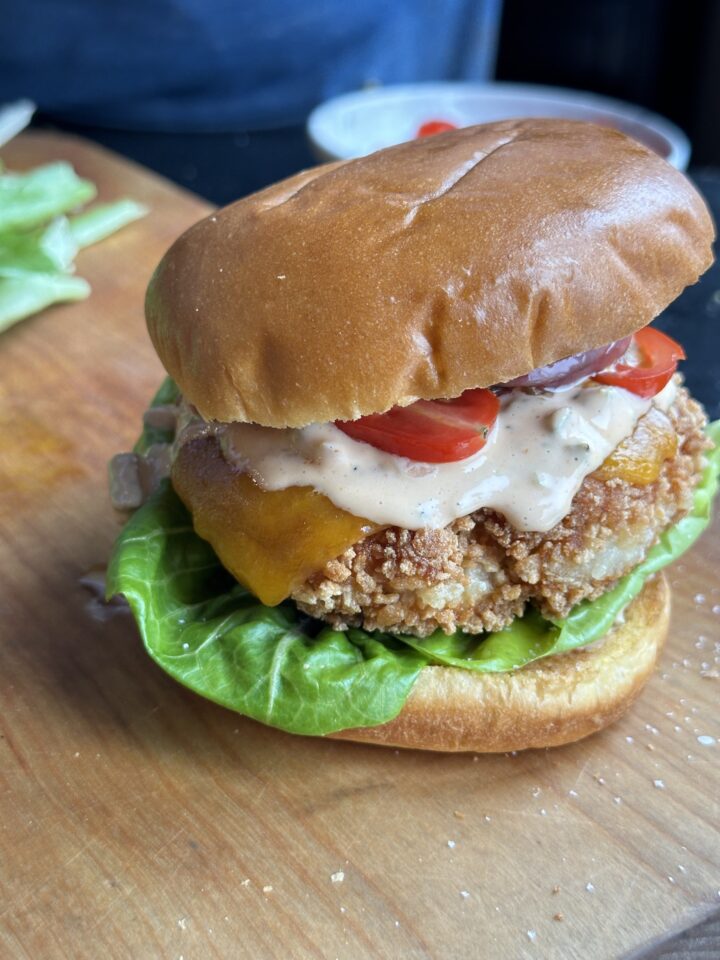 finished chicken burgers on cutting board