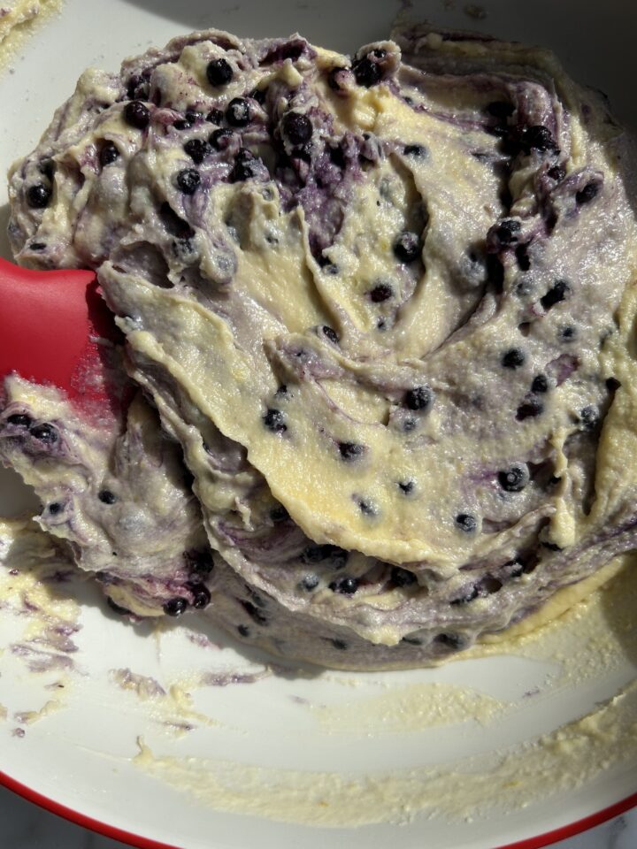 red spatula folding in the blueberries