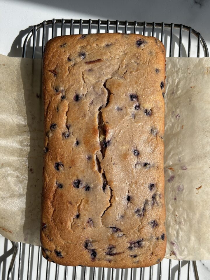 baked blueberry lemon cake on brown parchment paper