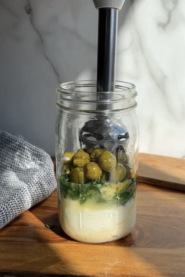 layers of creamy olive dressing in jar