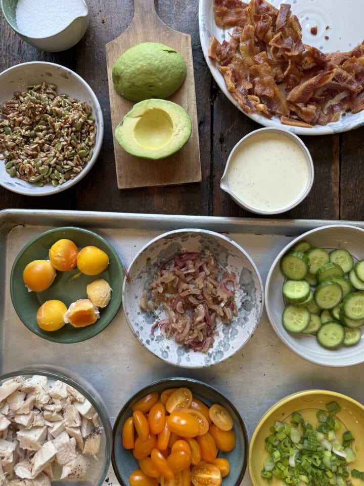 Fresh ingredients for healthy eating recipes, including tomatoes, cucumbers, bacon, chicken, avocado, and more.