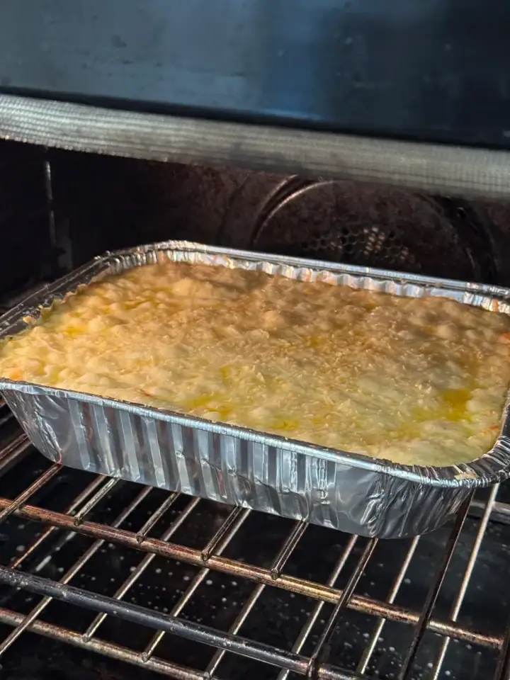 cheese souffle in a foil pan on an oven rack