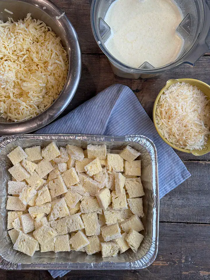bread and cheese in bowls on a wooden surface