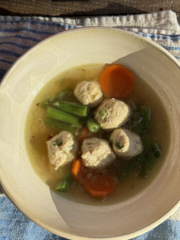 chicken soup with ginger in a white bowl