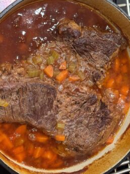 pot roast in a dutch oven on an oven rack