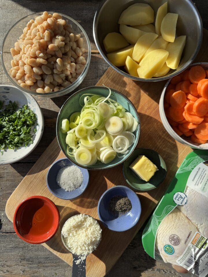 the ingredients for chicken thighs with potatoes and beans in small bowls