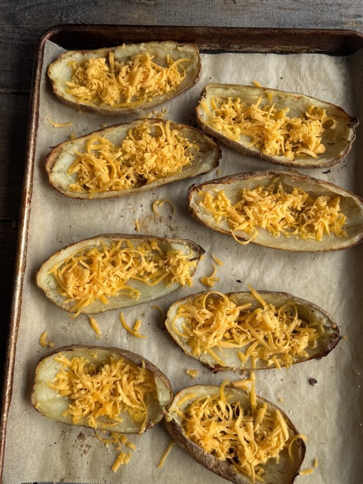 scooped out potato skins with cheddar cheese inside them