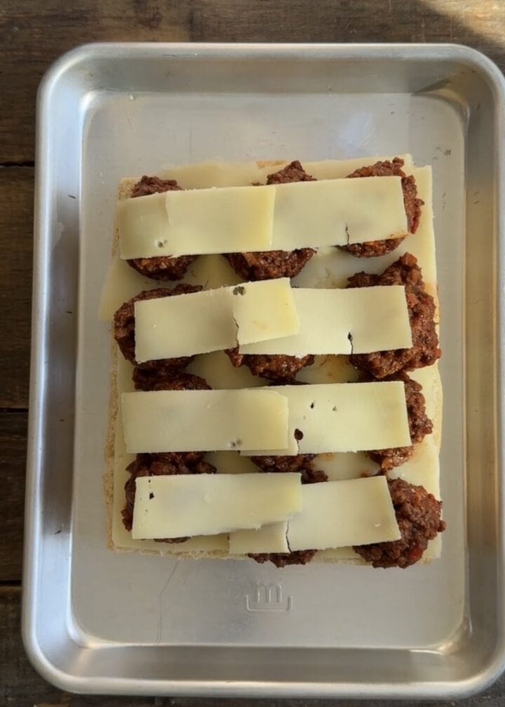 cheese layered on top of sloppy joe sliders