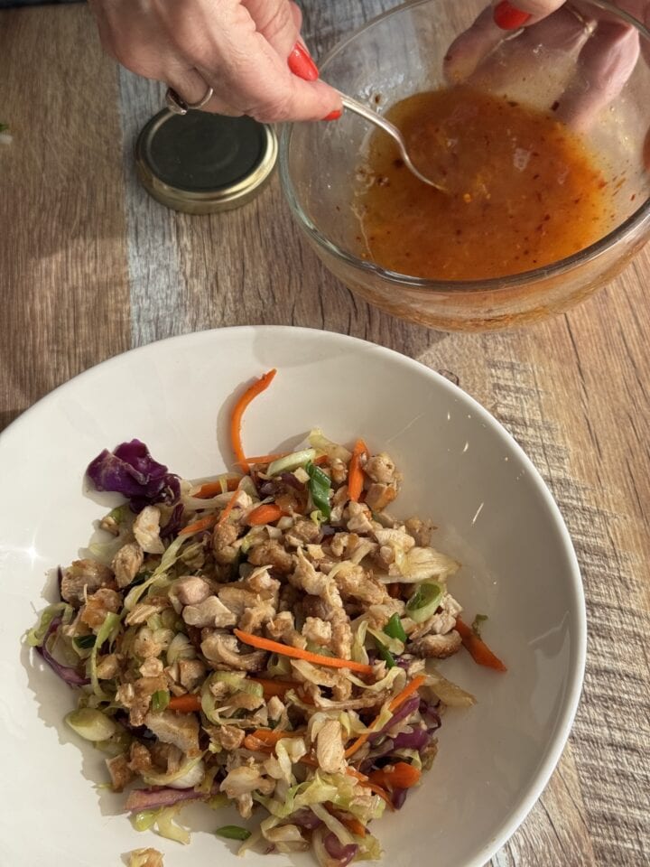 egg roll in a bowl with a bowl of sweet and sour sauce next to it